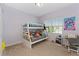Bedroom showcasing a bunk bed with stuffed animals, desk and chair, with plenty of natural light at 9348 Meadow Hunt Way, Winter Garden, FL 34787