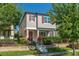 Charming two-story home with a red door, gray exterior paint and well-manicured landscaping at 9348 Meadow Hunt Way, Winter Garden, FL 34787