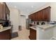 Well-equipped kitchen with stainless steel appliances, granite countertops, and ample wood cabinetry at 9348 Meadow Hunt Way, Winter Garden, FL 34787