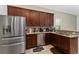 Well-equipped kitchen with stainless steel appliances, granite countertops, and ample wood cabinetry at 9348 Meadow Hunt Way, Winter Garden, FL 34787