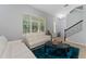 Bright and inviting living room featuring a modern seating arrangement and natural light at 9348 Meadow Hunt Way, Winter Garden, FL 34787