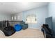 Cozy loft area with a blue recliner, beanbag chair, and natural light from a window at 9348 Meadow Hunt Way, Winter Garden, FL 34787