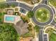 Aerial view showcasing a community pool, playground, and roundabout in a well-maintained neighborhood at 9559 Silver Buttonwood St, Orlando, FL 32832