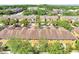 Aerial view of a row of colorful townhomes, showcasing trees and the community's architecture at 9559 Silver Buttonwood St, Orlando, FL 32832