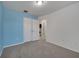 Bedroom with neutral carpet and light blue accent wall, featuring a double-door closet at 9559 Silver Buttonwood St, Orlando, FL 32832