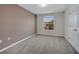 Bedroom with neutral carpet, brown accent wall, window, and white doors and trim at 9559 Silver Buttonwood St, Orlando, FL 32832