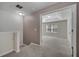 Hallway leading to a carpeted bedroom with a tray ceiling and bright natural light at 9559 Silver Buttonwood St, Orlando, FL 32832