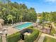 Upscale community pool and playground with ample seating and well-manicured landscaping under a bright sky at 9559 Silver Buttonwood St, Orlando, FL 32832