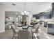 Bright dining room featuring stylish furnishings, a glass table, and open access to both the living room and kitchen at 9559 Silver Buttonwood St, Orlando, FL 32832
