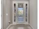 Elegant glass door framed by sidelights with serene views of the balcony, combining style and natural light at 9559 Silver Buttonwood St, Orlando, FL 32832
