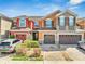 Charming townhome featuring colorful exteriors, attached garages, brick driveways, and lush landscaping for curb appeal at 9559 Silver Buttonwood St, Orlando, FL 32832