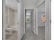 Bright hallway view with bathroom, bedroom, and bedroom/living room doors and neutral paint scheme at 9559 Silver Buttonwood St, Orlando, FL 32832
