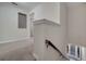Upstairs hallway with neutral carpet and trim, leading to various rooms at 9559 Silver Buttonwood St, Orlando, FL 32832