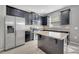 Well-equipped kitchen with modern appliances, granite countertops, dark cabinets, and tile flooring for style and functionality at 9559 Silver Buttonwood St, Orlando, FL 32832
