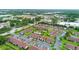Expansive aerial view of the condominium complex near surrounding shops, a lake, and community features at 101 Grand Plaza Dr # P6, Orange City, FL 32763
