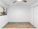 Simple bedroom features wood flooring, a ceiling fan, and a closet with white doors and ample space at 101 Grand Plaza Dr # P6, Orange City, FL 32763