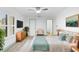 Bright bedroom featuring a ceiling fan, light-colored wood floors, and a stylish accent color at 101 Grand Plaza Dr # P6, Orange City, FL 32763