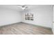 This light-filled room includes a ceiling fan and window with crisp, white shutters and sleek wood flooring at 101 Grand Plaza Dr # P6, Orange City, FL 32763