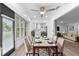 Bright dining room with a modern light fixture, view to living room, and large windows overlooking the neighborhood at 101 Grand Plaza Dr # P6, Orange City, FL 32763