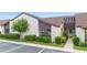 Exterior view of unit P-6 featuring green landscaping, adjacent parking, and a well-kept facade at 101 Grand Plaza Dr # P6, Orange City, FL 32763