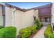 Exterior view showcases a sidewalk lined with manicured greenery, and neutral-toned facade at 101 Grand Plaza Dr # P6, Orange City, FL 32763