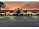 Exterior view of condos at dusk featuring illuminated windows, landscaping, and parking spaces at 101 Grand Plaza Dr # P6, Orange City, FL 32763