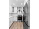 A modern kitchen featuring white cabinetry, stainless steel appliances, and a beautiful marble backsplash at 101 Grand Plaza Dr # P6, Orange City, FL 32763