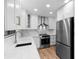 Modern kitchen with stainless steel appliances, white cabinetry, quartz counters and ample lighting at 101 Grand Plaza Dr # P6, Orange City, FL 32763