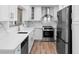 A modern kitchen featuring white cabinetry, stainless steel appliances, and a beautiful marble backsplash at 101 Grand Plaza Dr # P6, Orange City, FL 32763