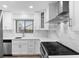 Bright kitchen with white cabinets, stainless steel appliances and a modern sink at 101 Grand Plaza Dr # P6, Orange City, FL 32763