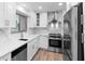 Modern kitchen with white cabinets, stainless steel appliances and a large window at 101 Grand Plaza Dr # P6, Orange City, FL 32763