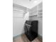 Modern laundry room features a black washer and dryer and white built-in shelving at 101 Grand Plaza Dr # P6, Orange City, FL 32763