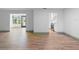 Open living space with modern flooring, seamlessly connecting to the kitchen with white cabinets at 101 Grand Plaza Dr # P6, Orange City, FL 32763