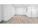 An empty living room with light wood floors, white walls, and green trim at 101 Grand Plaza Dr # P6, Orange City, FL 32763