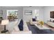 Staged living room showcases a modern sofa, stylish decor, and an inviting dining area at 101 Grand Plaza Dr # P6, Orange City, FL 32763
