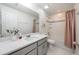 Well-lit bathroom featuring a neutral vanity, a large mirror, and shower with pink curtain at 10221 Highline Crest St, Orlando, FL 32832