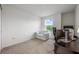 Bright and versatile bedroom with a view, desk, and comfortable white love seat at 10221 Highline Crest St, Orlando, FL 32832