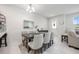 Dining room featuring an elegant table, six chairs, decor, and bright natural light at 10221 Highline Crest St, Orlando, FL 32832