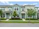 Charming townhome featuring a light green exterior, well-manicured landscaping, and welcoming front porch at 10221 Highline Crest St, Orlando, FL 32832