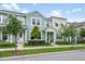 Charming townhome showcasing a well-manicured lawn, lush landscaping, and welcoming entrance at 10221 Highline Crest St, Orlando, FL 32832
