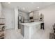 Modern kitchen featuring sleek stainless steel appliances, gray cabinets, stylish backsplash, and a large island at 10221 Highline Crest St, Orlando, FL 32832