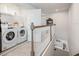 Upstairs laundry area with modern appliances conveniently located near a well-lit staircase at 10221 Highline Crest St, Orlando, FL 32832