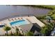Beautiful community pool overlooking the water and features ample seating and lounge chairs at 10221 Highline Crest St, Orlando, FL 32832