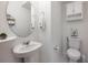 Clean and simple powder room featuring a modern sink, toilet, and minimalist decor at 10221 Highline Crest St, Orlando, FL 32832