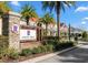 Randal Walk community entrance featuring lush landscaping and colorful, well maintained townhomes at 10221 Highline Crest St, Orlando, FL 32832