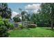 View of the backyard with green grass, landscaping, and trees adding to the property's privacy at 104 Forest Point Ln, Longwood, FL 32779