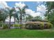 Beautiful backyard featuring lush lawn, mature trees, a swimming pool, and well-maintained landscaping at 104 Forest Point Ln, Longwood, FL 32779