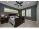 Bedroom with a neutral color scheme, a ceiling fan, and two windows with plantation shutters at 104 Forest Point Ln, Longwood, FL 32779