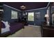 Bedroom with dark walls, modern ceiling fan, and a desk for work or play at 104 Forest Point Ln, Longwood, FL 32779
