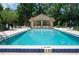Inviting community pool with lounge chairs and a covered pavilion for relaxing poolside at 104 Forest Point Ln, Longwood, FL 32779